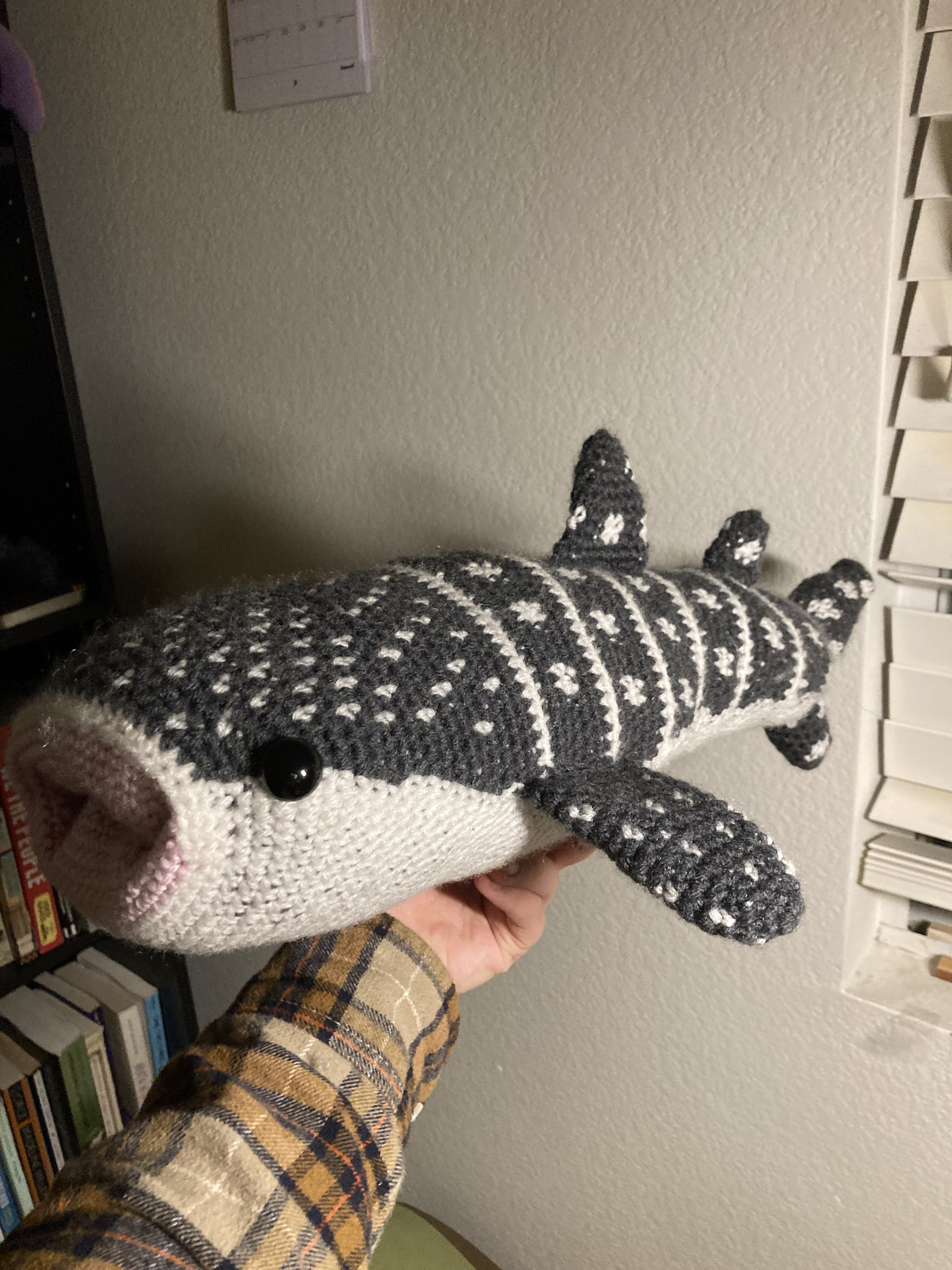 A picture of a very large crocheted whale shark.